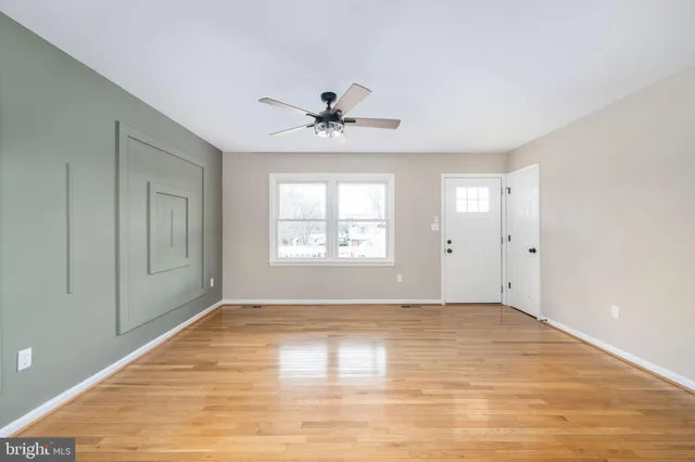 wooden floor in an empty room with a window