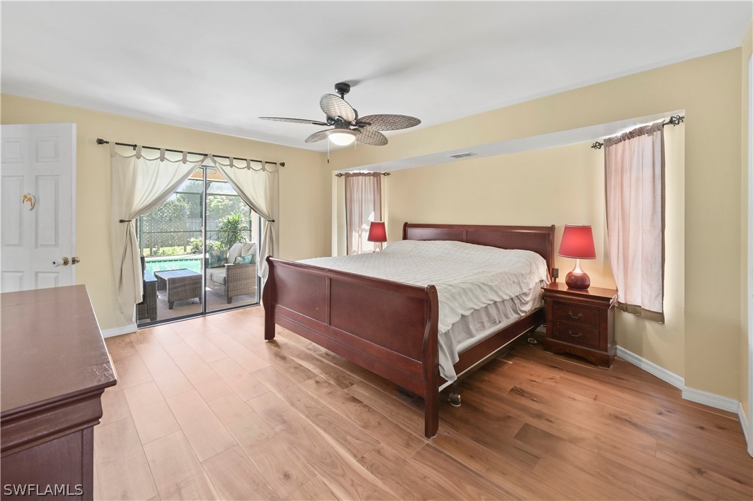 17413 Butler Road Fort Myers, FL 33967 - Photo 12 of 33 a bedroom with a large bed and a chandelier