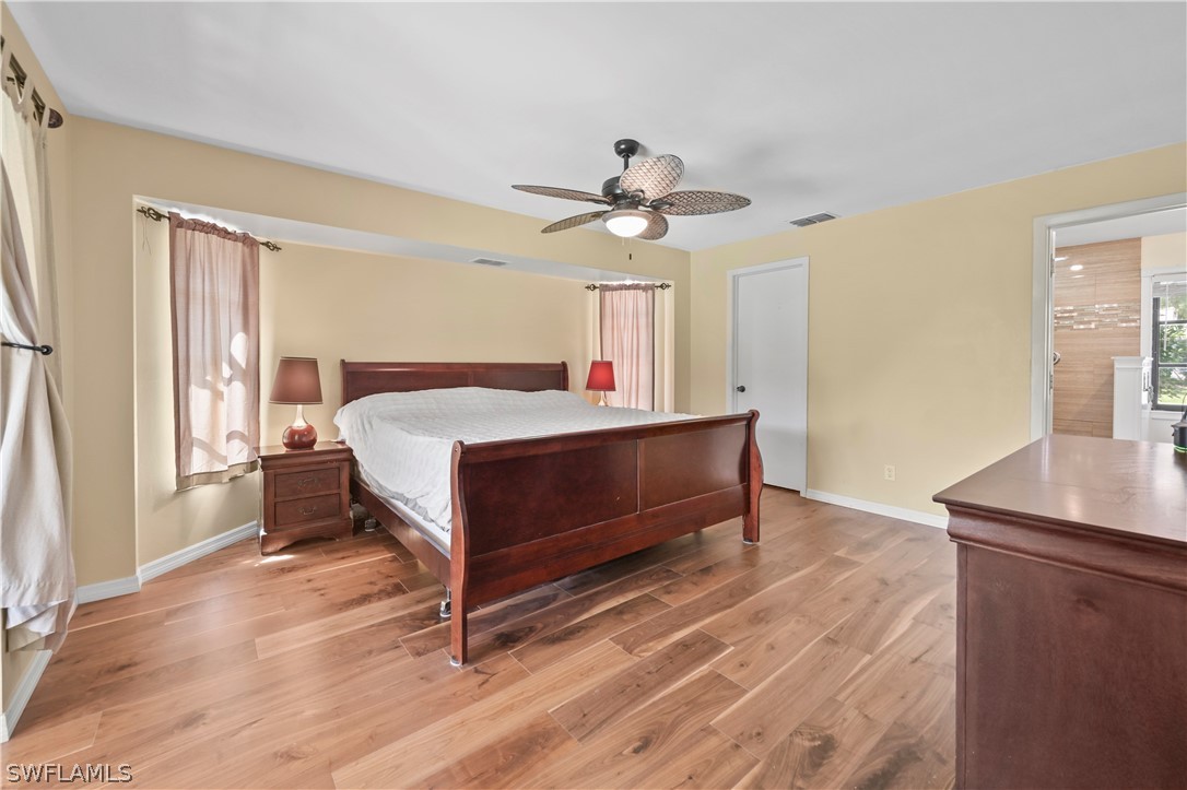 17413 Butler Road Fort Myers, FL 33967 - Photo 14 of 33 a bedroom with a bed and a chandelier