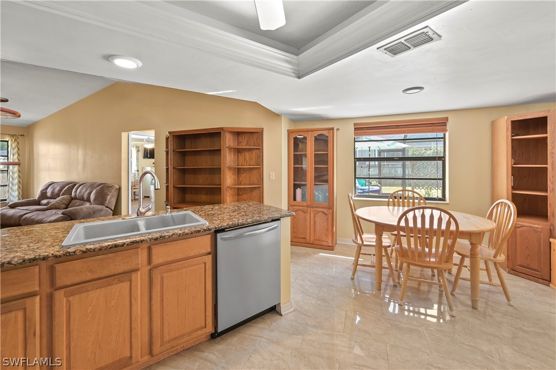 17413 Butler Road Fort Myers, FL 33967 - Photo 19 of 33 a dining hall with stainless steel appliances granite countertop a dining table and chairs