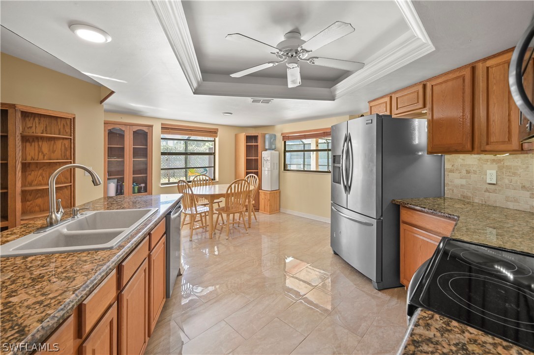17413 Butler Road Fort Myers, FL 33967 - Photo 20 of 33 a kitchen with stainless steel appliances granite countertop a sink stove and refrigerator