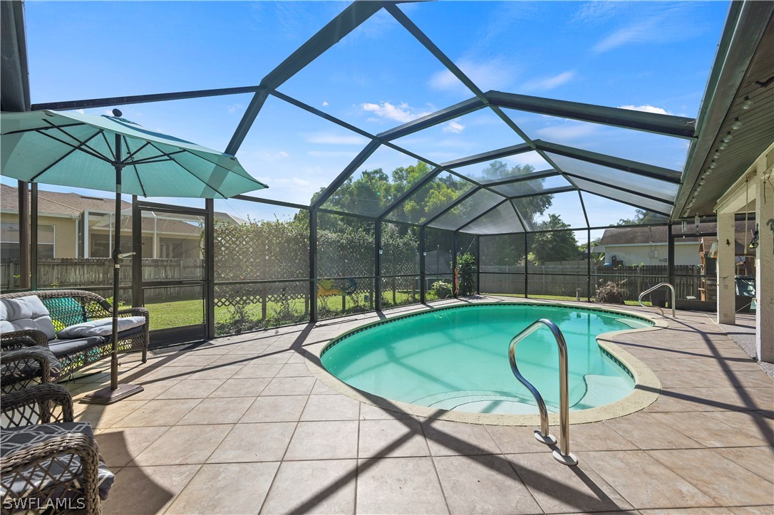 17413 Butler Road Fort Myers, FL 33967 - Photo 2 of 33 a swimming pool with a garden view