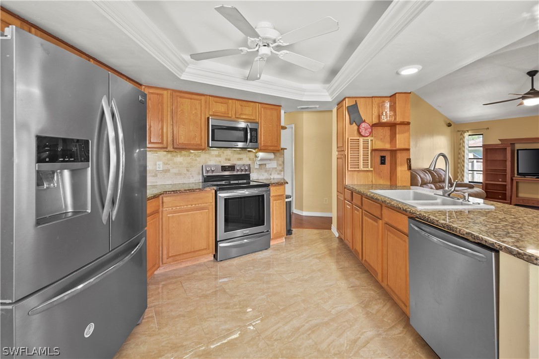 17413 Butler Road Fort Myers, FL 33967 - Photo 22 of 33 a large kitchen with stainless steel appliances granite countertop a stove top oven a refrigerator and a sink