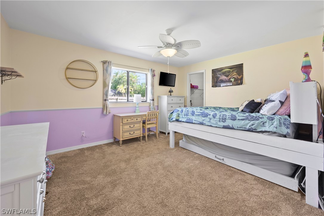 17413 Butler Road Fort Myers, FL 33967 - Photo 9 of 33 a bedroom with a bed and a chandelier