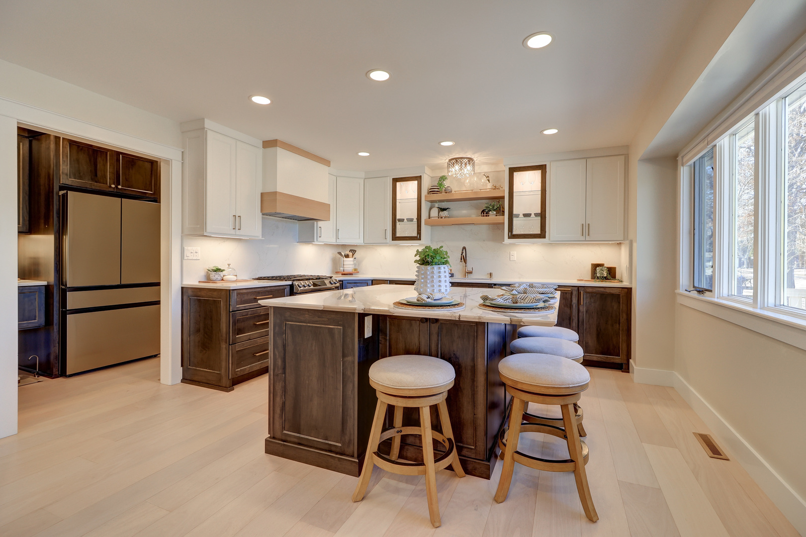 12749 Lawrence Road Sterling, IL 61081 - Photo 6 of 45 a kitchen with a refrigerator a stove a sink and a dining table with wooden floor