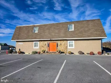 a kitchen with stainless steel appliances granite countertop a table chairs sink and cabinets