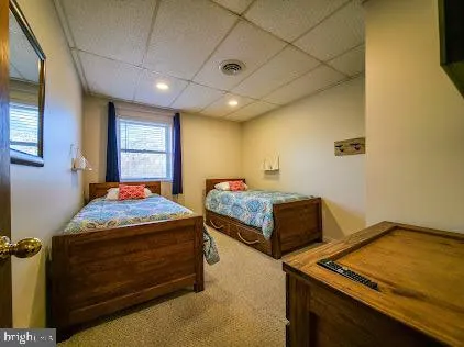 a bedroom with a large bed and wooden floor