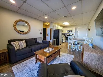 a living room with furniture a window and a clock