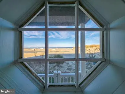a view of a brick house with a small yard and wooden fence