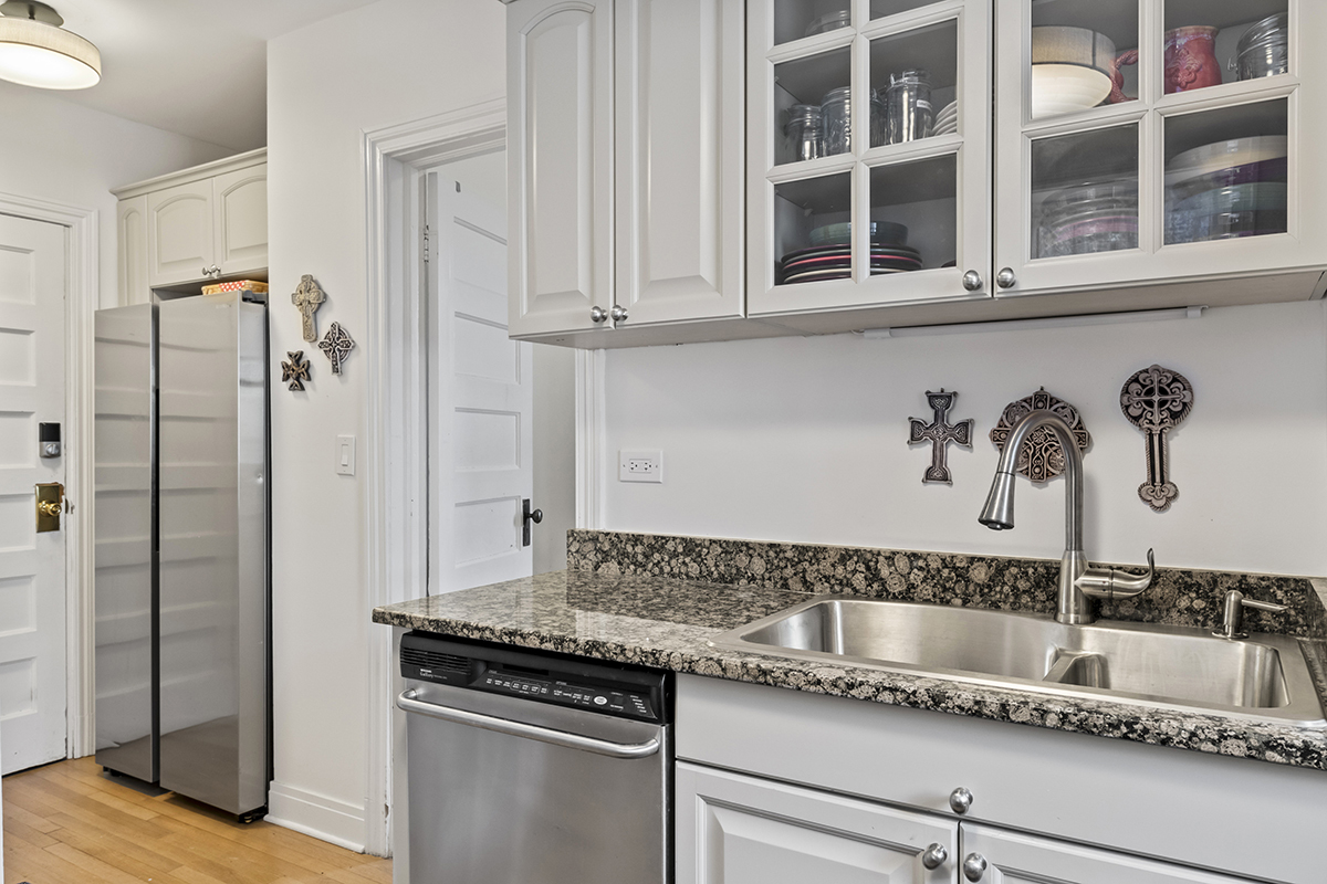 670 West Irving Park Road, Unit G6 Chicago, IL 60613 - Photo 24 of 38 a kitchen with stainless steel appliances granite countertop a sink and a granite counter tops