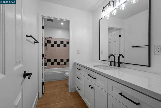 a bathroom with a double vanity sink and mirror
