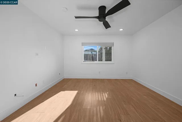 an empty room with a empty space and a ceiling fan