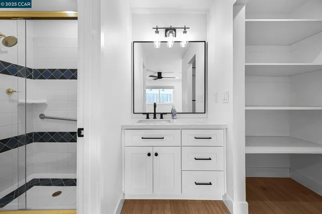 a bathroom with a bathtub sink and mirror