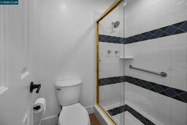 a bathroom with a toilet and a shower