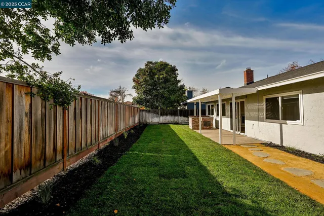 a view of house with backyard and entertaining space