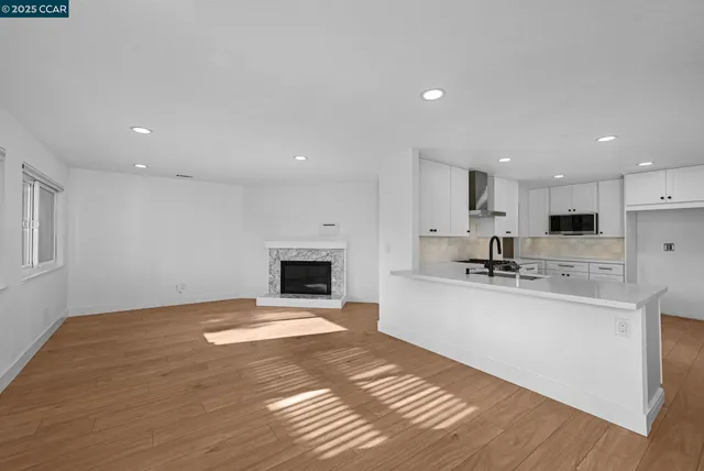 a view of kitchen with sink and refrigerator