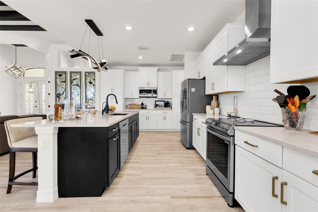 48 Master Drive Placida, FL 33946 - Photo 16 of 61 a kitchen with stainless steel appliances granite countertop a sink stove and refrigerator