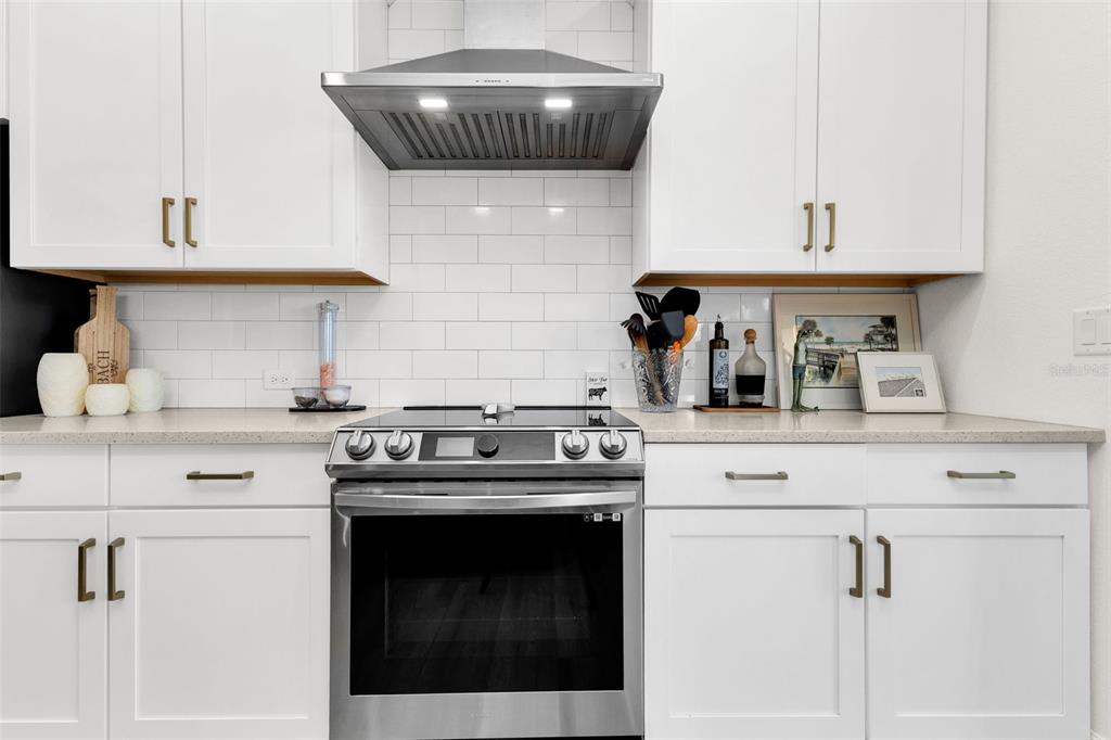 48 Master Drive Placida, FL 33946 - Photo 17 of 61 a kitchen with a stove and white cabinets
