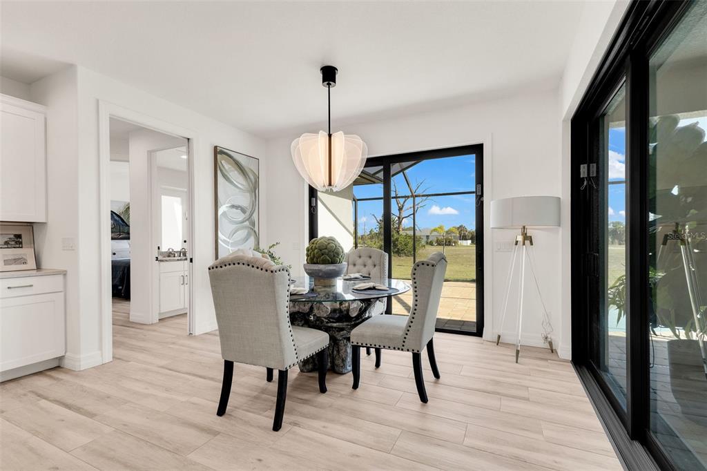 48 Master Drive Placida, FL 33946 - Photo 20 of 61 a view of a dining room with furniture window and wooden floor