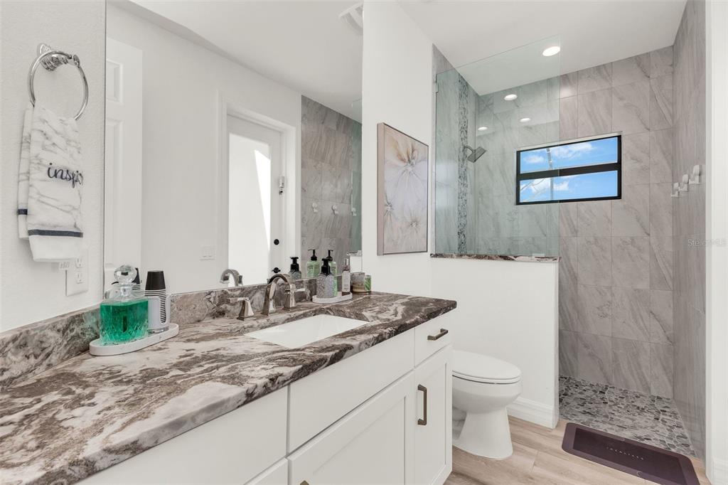48 Master Drive Placida, FL 33946 - Photo 22 of 61 a bathroom with a granite countertop sink mirror and toilet
