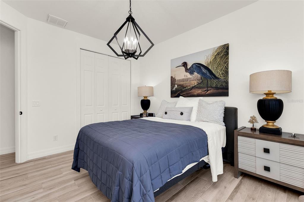 48 Master Drive Placida, FL 33946 - Photo 25 of 61 a bedroom with a bed and a chandelier