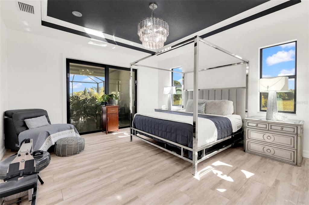 48 Master Drive Placida, FL 33946 - Photo 28 of 61 a bed room with a bed and a chandelier