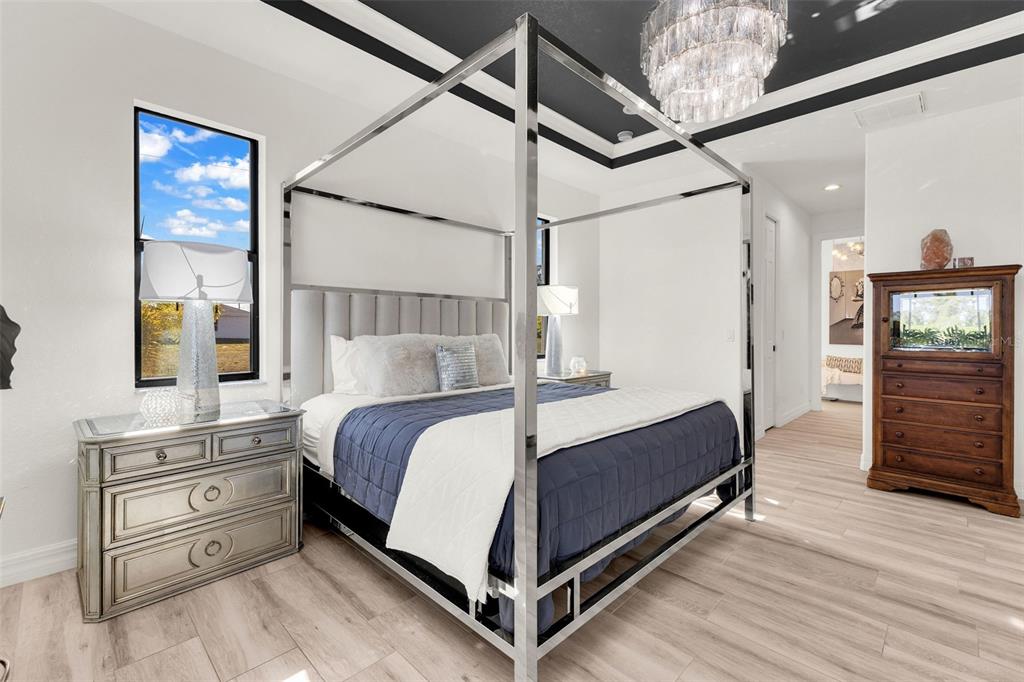 48 Master Drive Placida, FL 33946 - Photo 29 of 61 a bed room with a bed and a chandelier