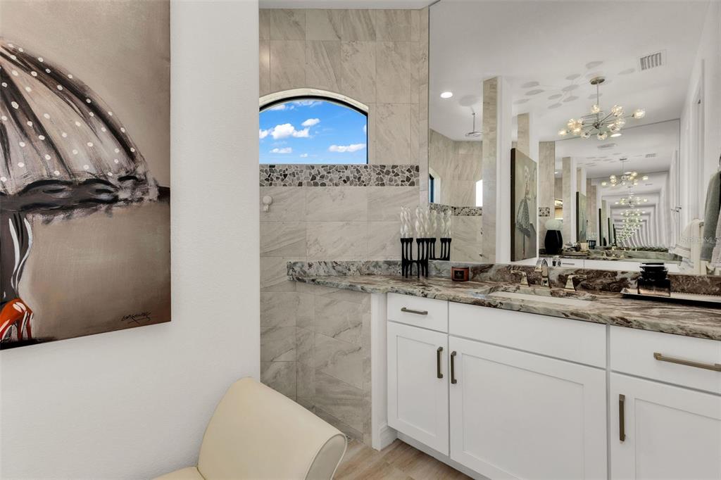 48 Master Drive Placida, FL 33946 - Photo 32 of 61 a bathroom with a granite countertop sink a toilet and a mirror