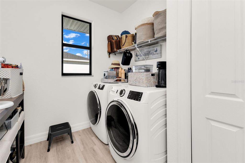 48 Master Drive Placida, FL 33946 - Photo 36 of 61 a utility room with dryer washer and a view of living room