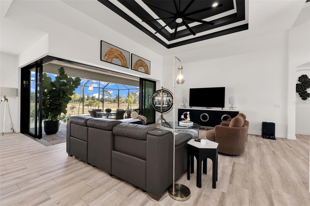 48 Master Drive Placida, FL 33946 - Photo 9 of 61 a living room with furniture a flat screen tv and a floor to ceiling window