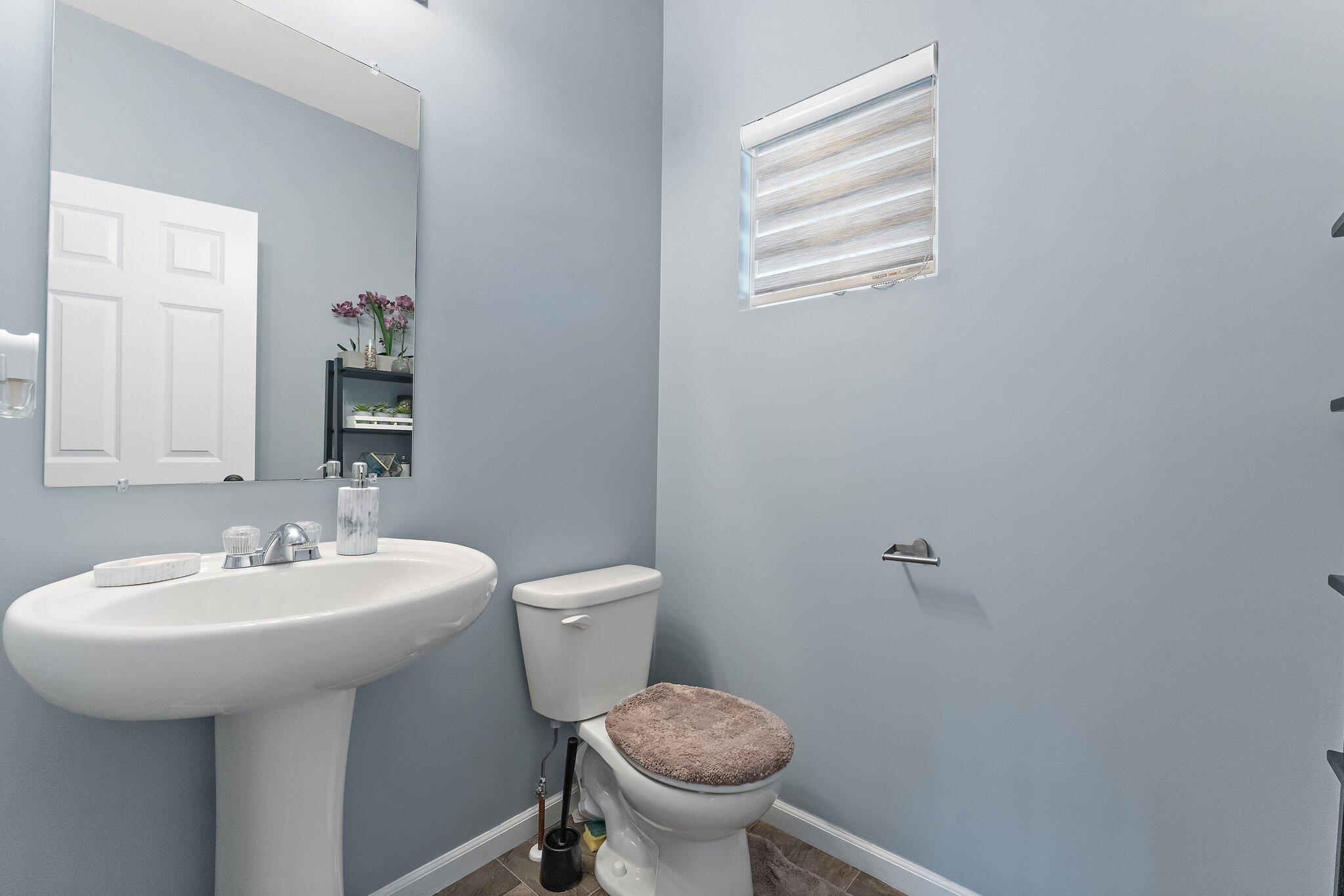11539 Georgia Place Crown Point, IN 46307 - Photo 17 of 37 a bathroom with a sink toilet and a mirror