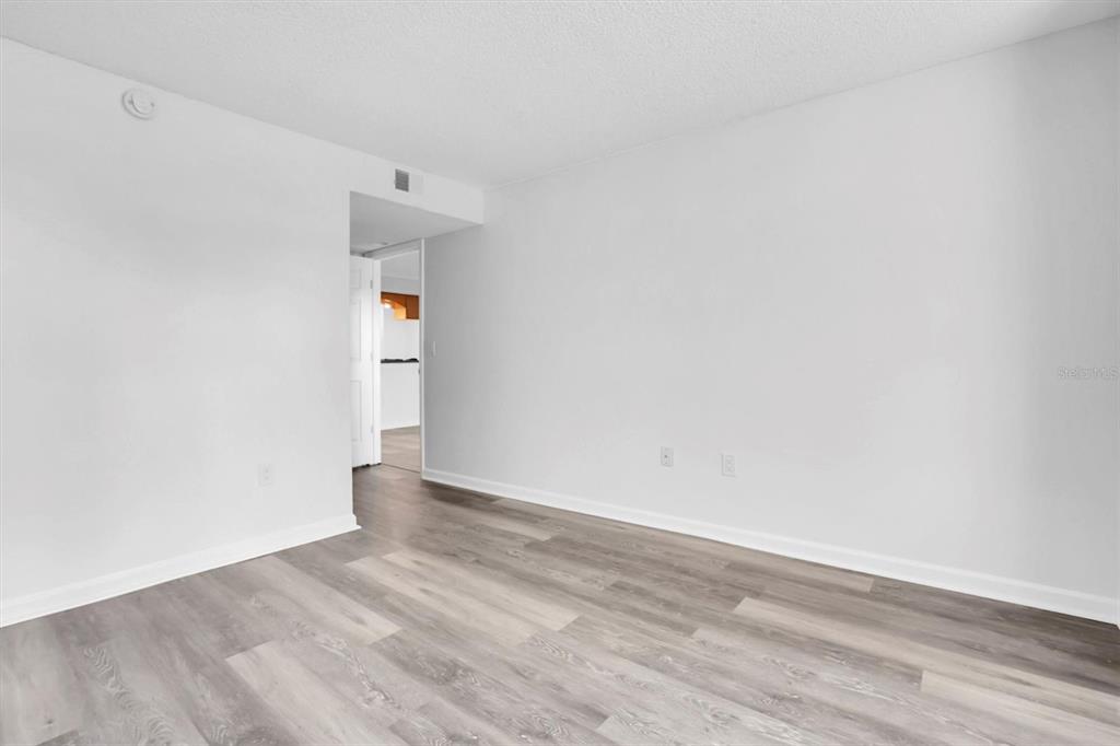 2500 Winding Creek Boulevard, Unit A104 Clearwater, FL 33761 - Photo 16 of 31 a view of an empty room with wooden floor and a window