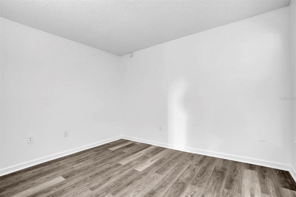 2500 Winding Creek Boulevard, Unit A104 Clearwater, FL 33761 - Photo 17 of 31 a view of wooden floor in a room