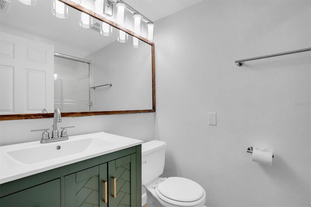 2500 Winding Creek Boulevard, Unit A104 Clearwater, FL 33761 - Photo 18 of 31 a bathroom with a sink toilet and mirror