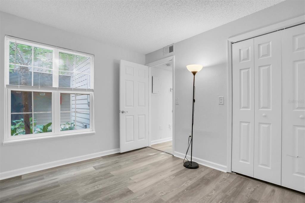 2500 Winding Creek Boulevard, Unit A104 Clearwater, FL 33761 - Photo 20 of 31 an empty room with wooden floor and windows