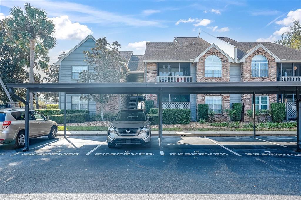 2500 Winding Creek Boulevard, Unit A104 Clearwater, FL 33761 - Photo 2 of 31 a view of a brick house with a yard and sitting space