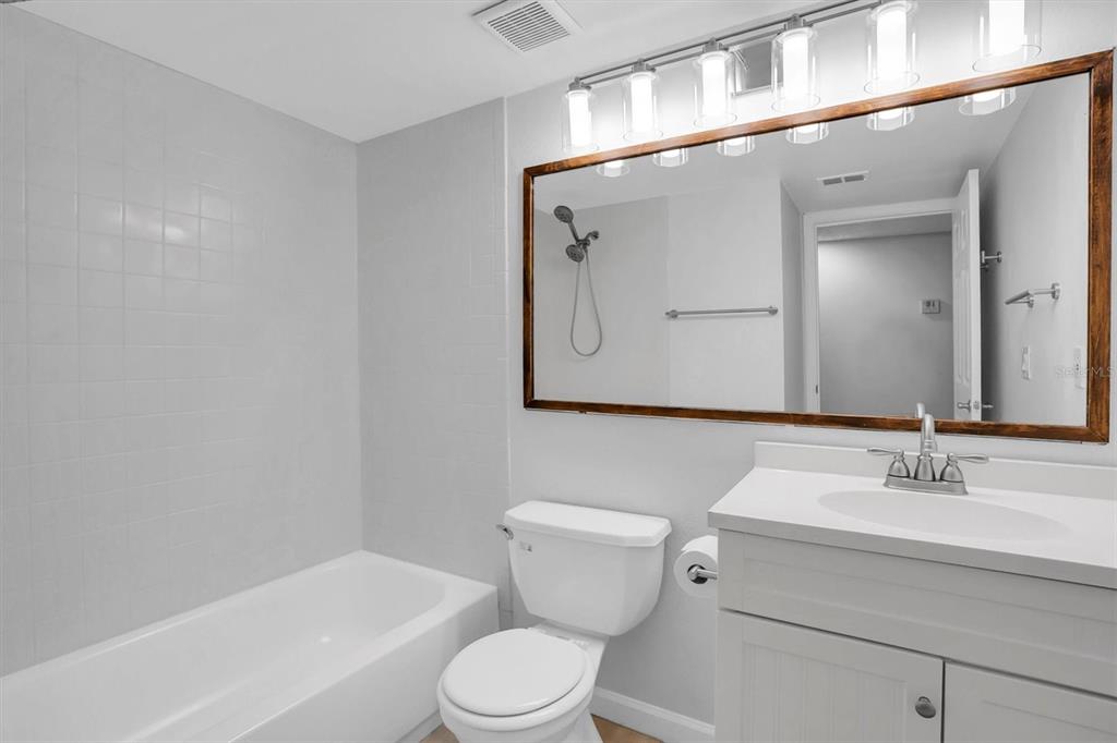 2500 Winding Creek Boulevard, Unit A104 Clearwater, FL 33761 - Photo 21 of 31 a bathroom with a toilet a sink and a bathtub