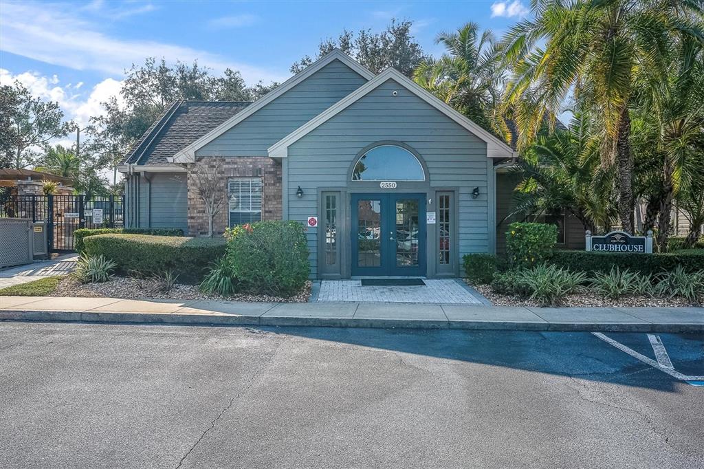 2500 Winding Creek Boulevard, Unit A104 Clearwater, FL 33761 - Photo 26 of 31 a front view of a house with a yard and a garage