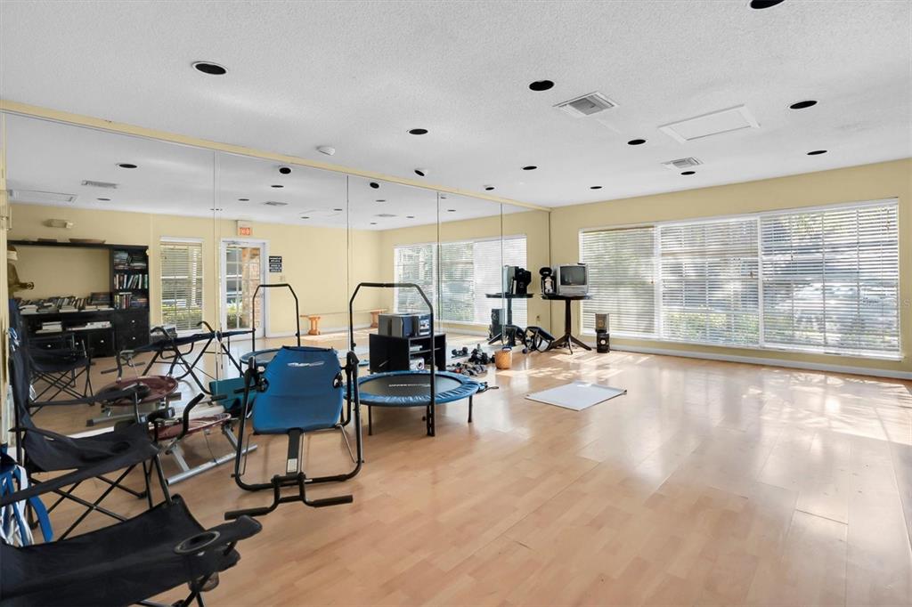 2500 Winding Creek Boulevard, Unit A104 Clearwater, FL 33761 - Photo 30 of 31 a view of a kitchen with dining table and chairs