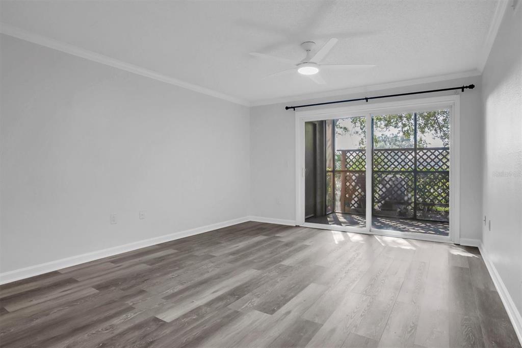 2500 Winding Creek Boulevard, Unit A104 Clearwater, FL 33761 - Photo 5 of 31 a view of an empty room with wooden floor and a window