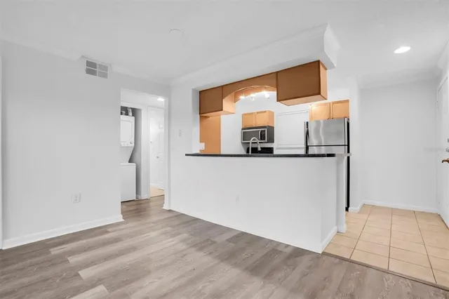 a view of a kitchen cabinets a wooden floor and a kitchen space