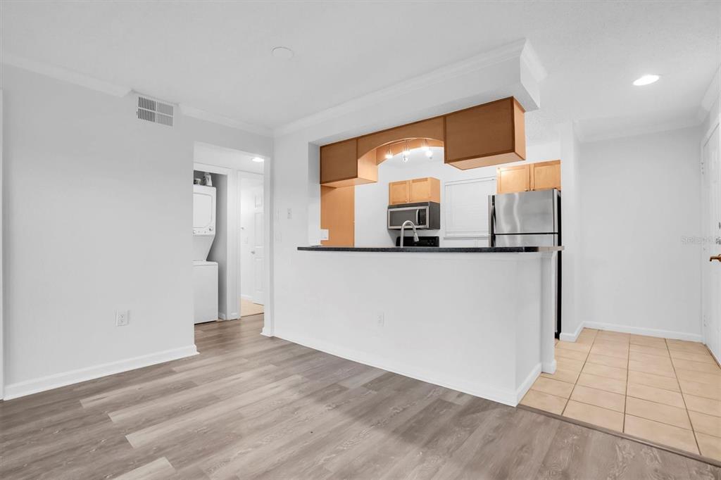 2500 Winding Creek Boulevard, Unit A104 Clearwater, FL 33761 - Photo 9 of 31 a view of a kitchen cabinets a wooden floor and a kitchen space