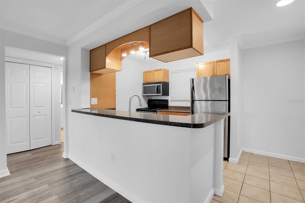 2500 Winding Creek Boulevard, Unit A104 Clearwater, FL 33761 - Photo 10 of 31 a kitchen with stainless steel appliances a refrigerator and a stove