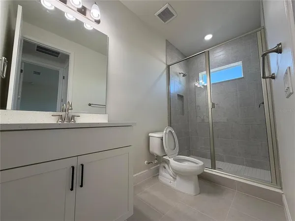 a bathroom with a toilet sink and shower