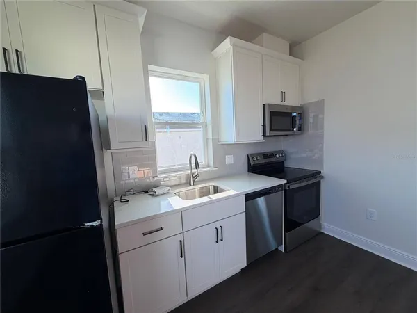 a kitchen with a sink stove and refrigerator