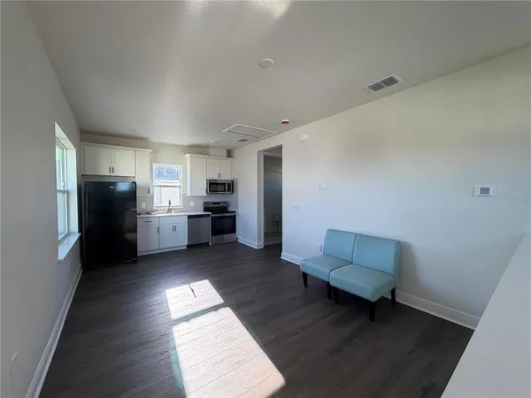 a kitchen with a refrigerator and a sink