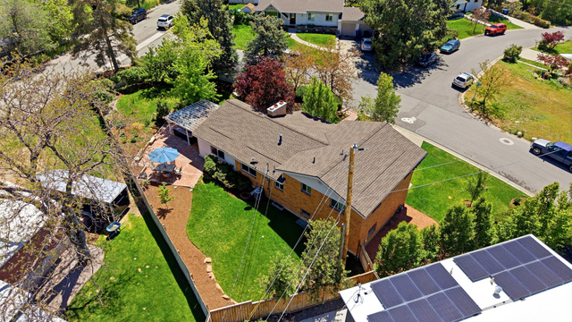 4245 3320 East Holladay, UT 84124 - Photo 4 of 51 Spacious backyard featuring a manicured lawn, a paved patio, and mature trees
