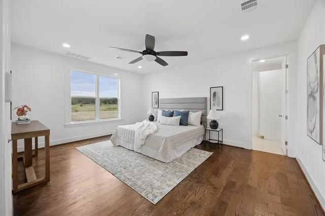 a bed room with a bed a window and a chandelier