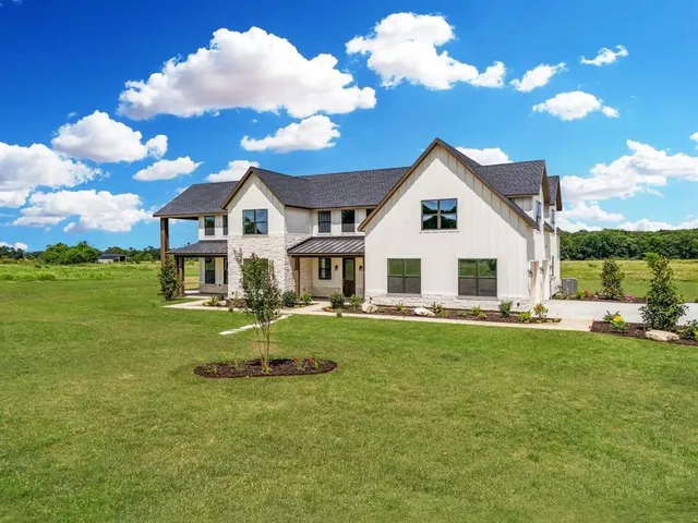 a view of a house with a yard porch and sitting area