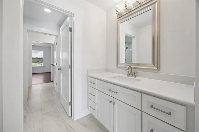 a en suite bathroom with a sink and a mirror